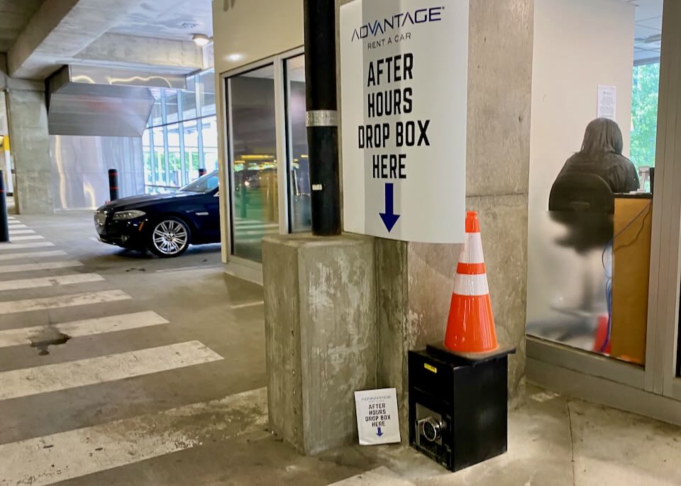 Sign with an arrow pointing down to a black box, stating, "After hours drop box here."