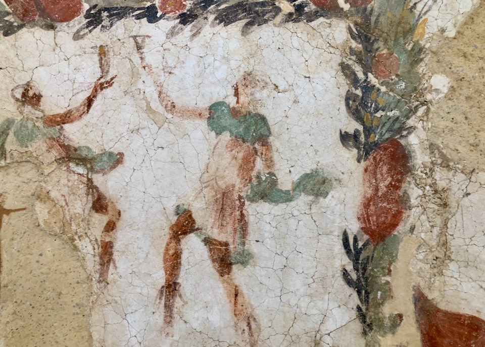 Faded frescoe painting of two figures toasting with goblets