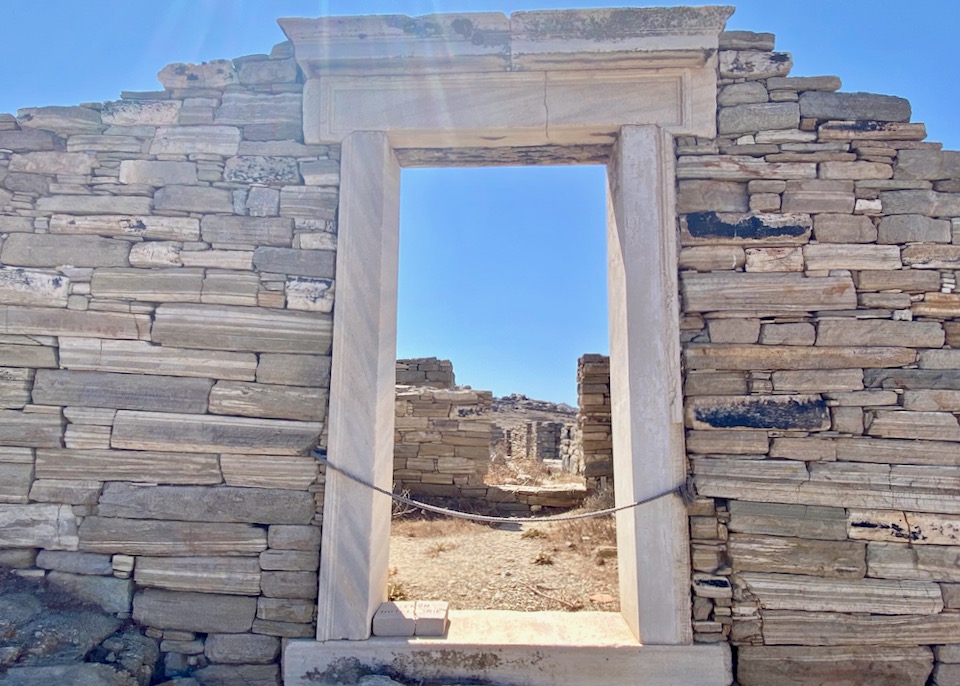Ancient stone window framing a blue sky 