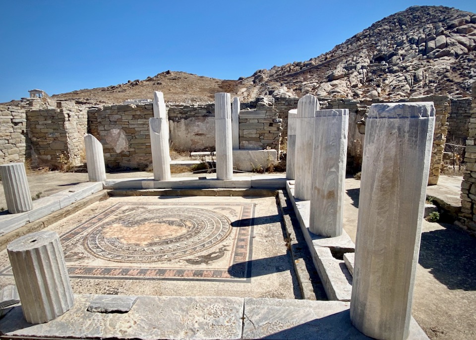 Stone pillars set in a square around a stone mosaic floor