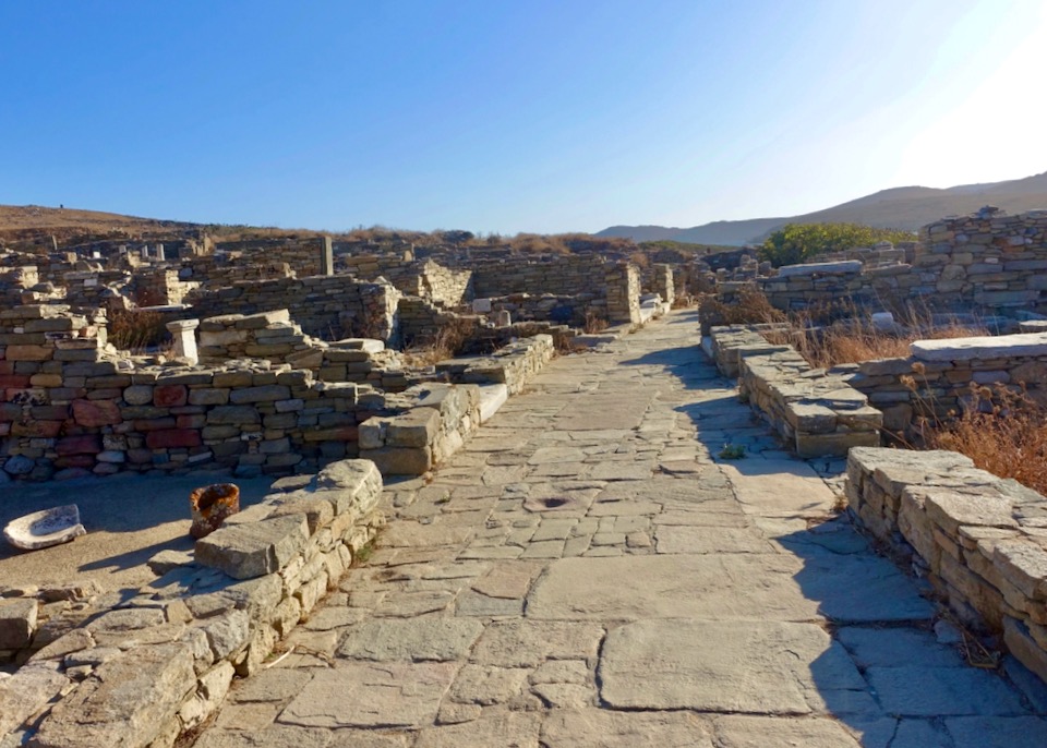 An empty stone walkway surrounded by ancient ruins.