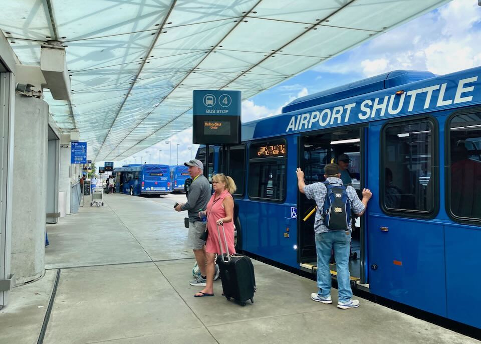 People exit an Airport Shuttle bus.