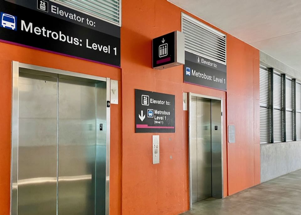 Orange elevators to the Metrobus, level 1.