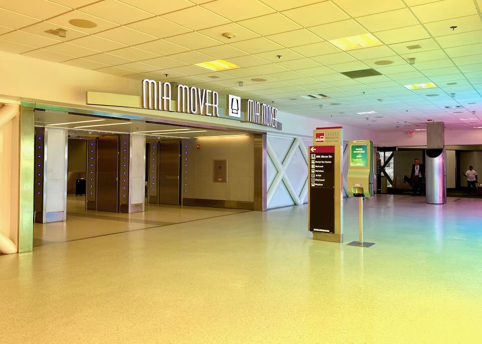 The entrance to the MIA Mover is bathed in yellow light.