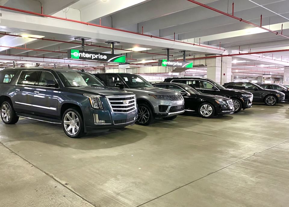 Vehicles sit in the Enterprise parking lot.