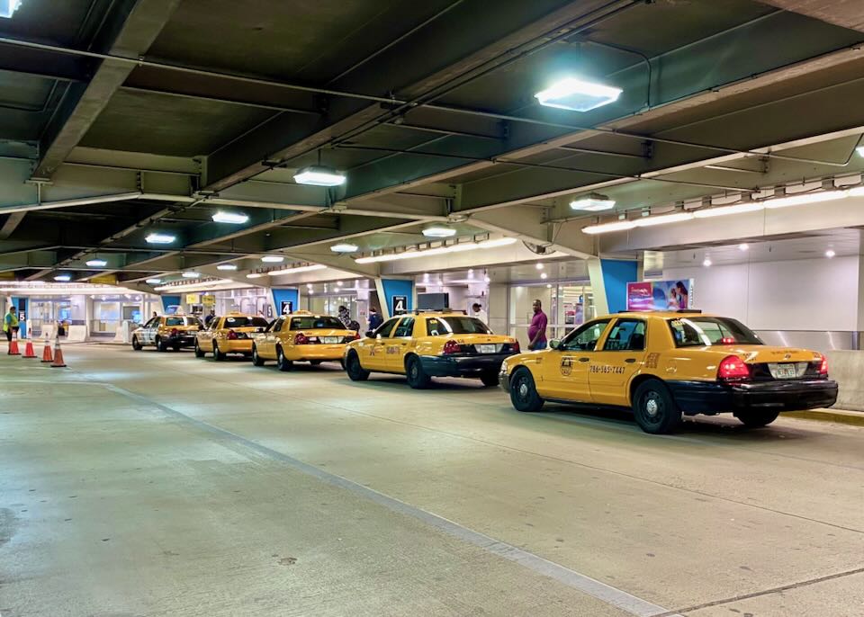Taxis line up outside the airport.