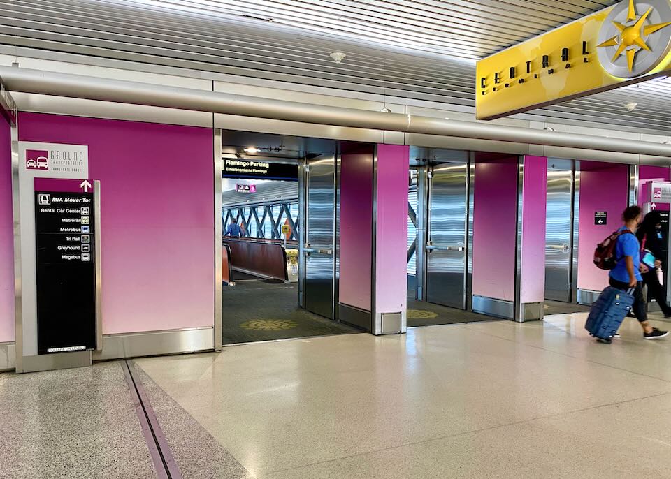 People walk through pink doors in Central Terminal.
