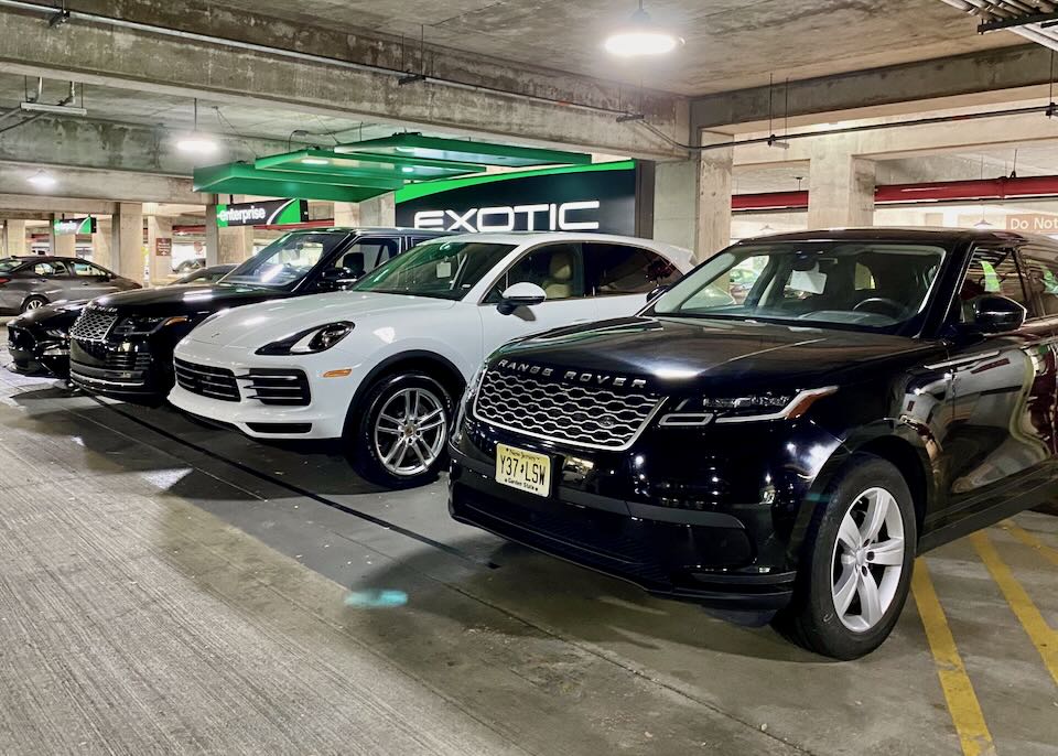 A Range Rover and Mustang sit parked in the garage.