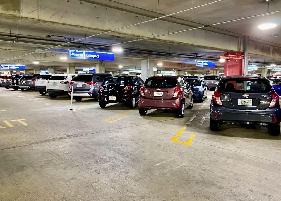 Cars sit in the Alamo compact section of the parking garage.