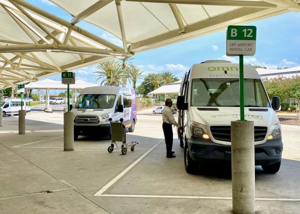 Off-airport shuttles wait in parking spots B11 and B12.