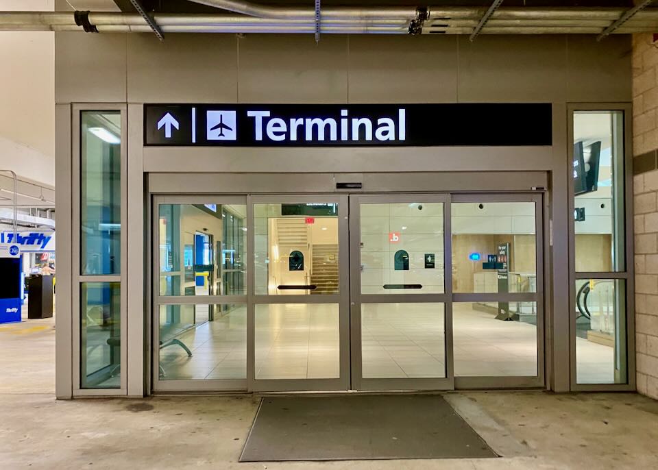 A sign reads Terminal above doors to escalators.