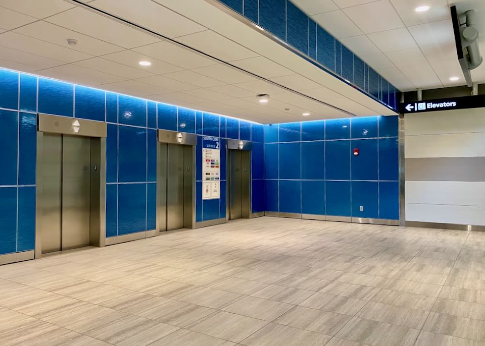 Blue tiles surround the elevators.