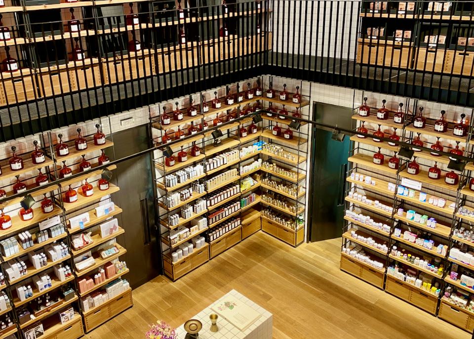 Overhead view of a shop lined floor to ceiling with shelves of beauty products