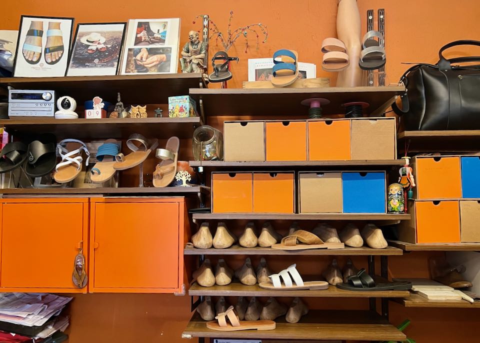 Shelves of leather sandals and photos on display