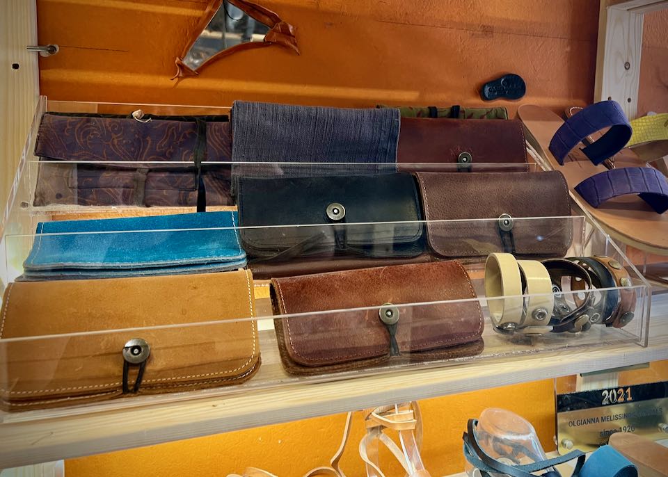 A variety of leather wallets on display on a shop shelf.