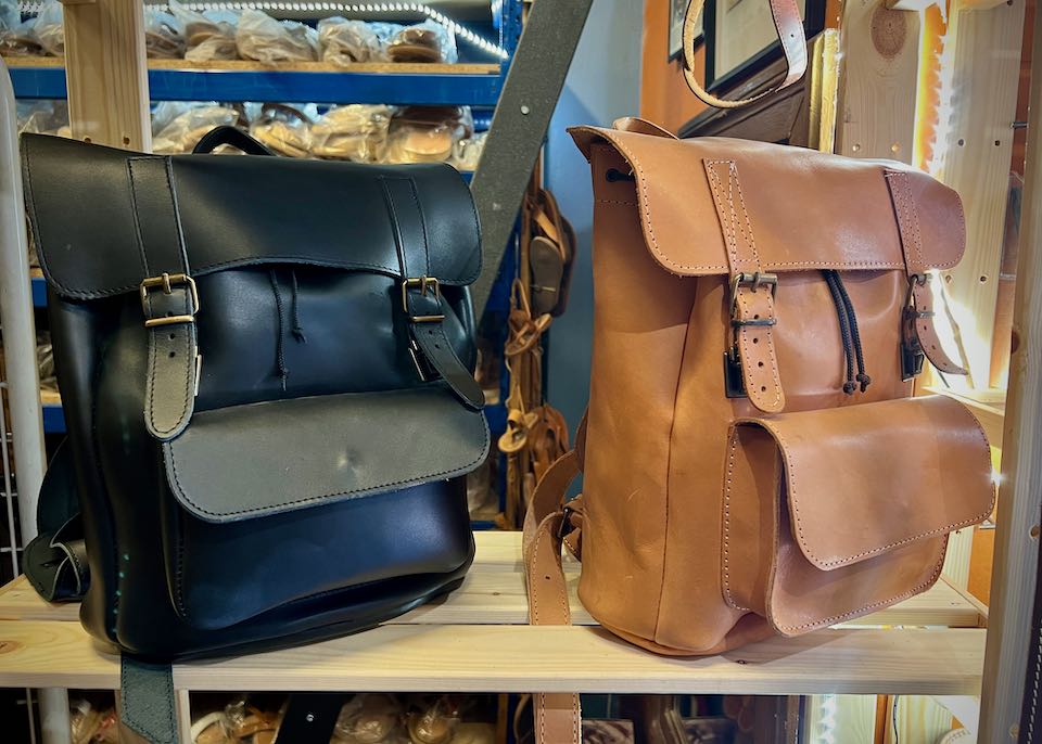Leather backpacks on display on a shelf