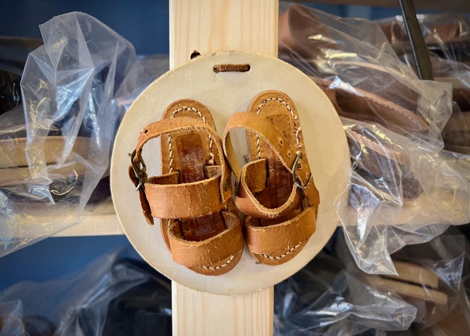 Small leather baby-sized sandals on display in a shop