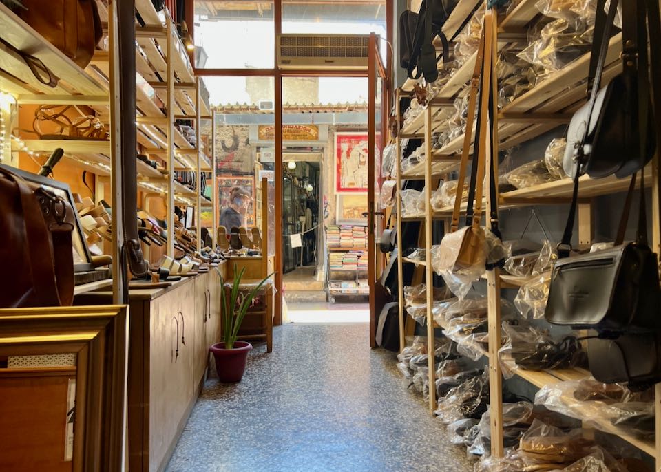 Interior of a shop, with leather sandals and accessories lining the shelves