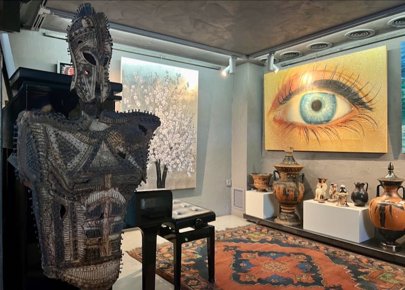 Paintings and sculpture on display in an art gallery