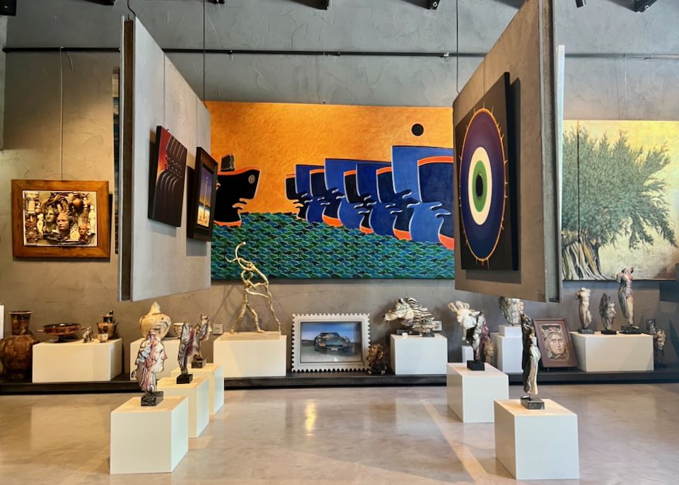 Gallery space hung with colorful contemporary paintings