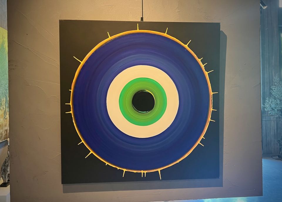 Large abstract painting resembling a Greek "evel eye" icon