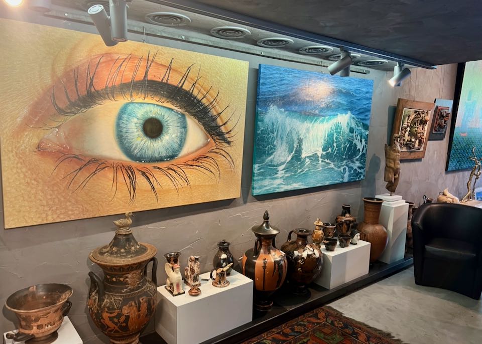 Paintings and sculpture displayed in a gallery