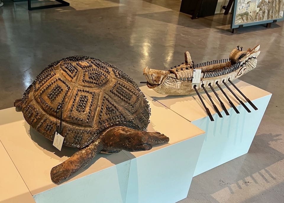 Wood and nail sculptures of a tortoise and a Greek ship