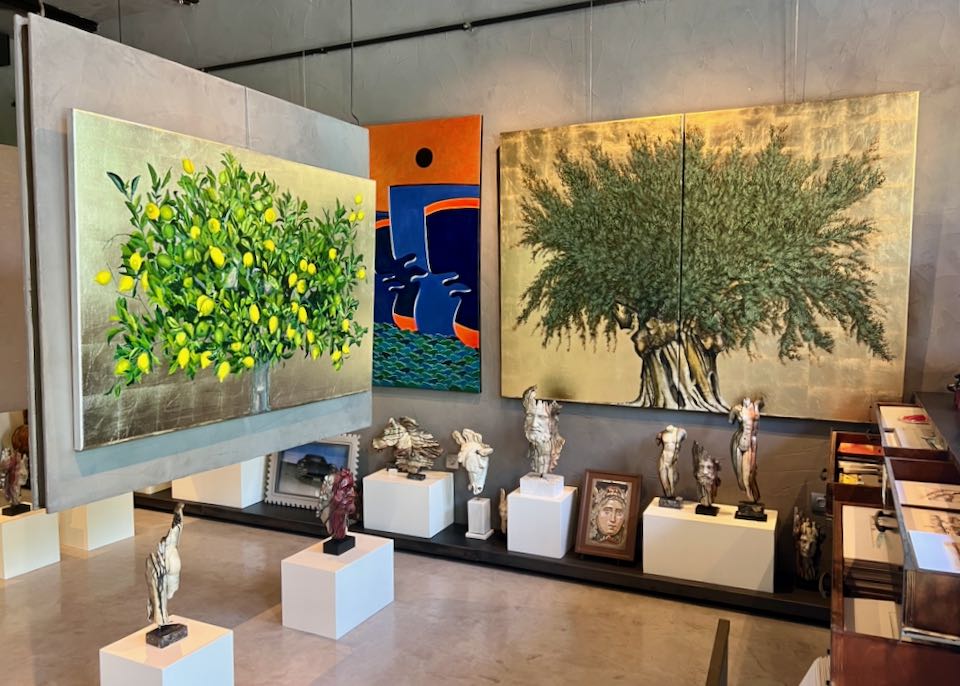 Art gallery with colorful paintings and ceramic sculpture