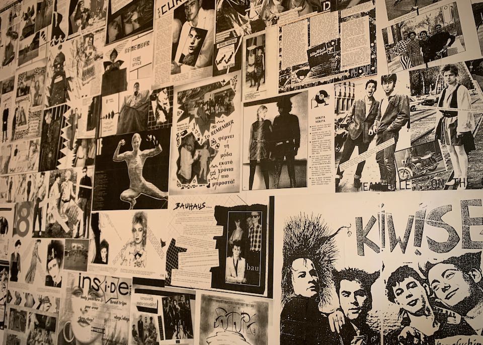 Collage wall with black and white photos of punk and rock bands