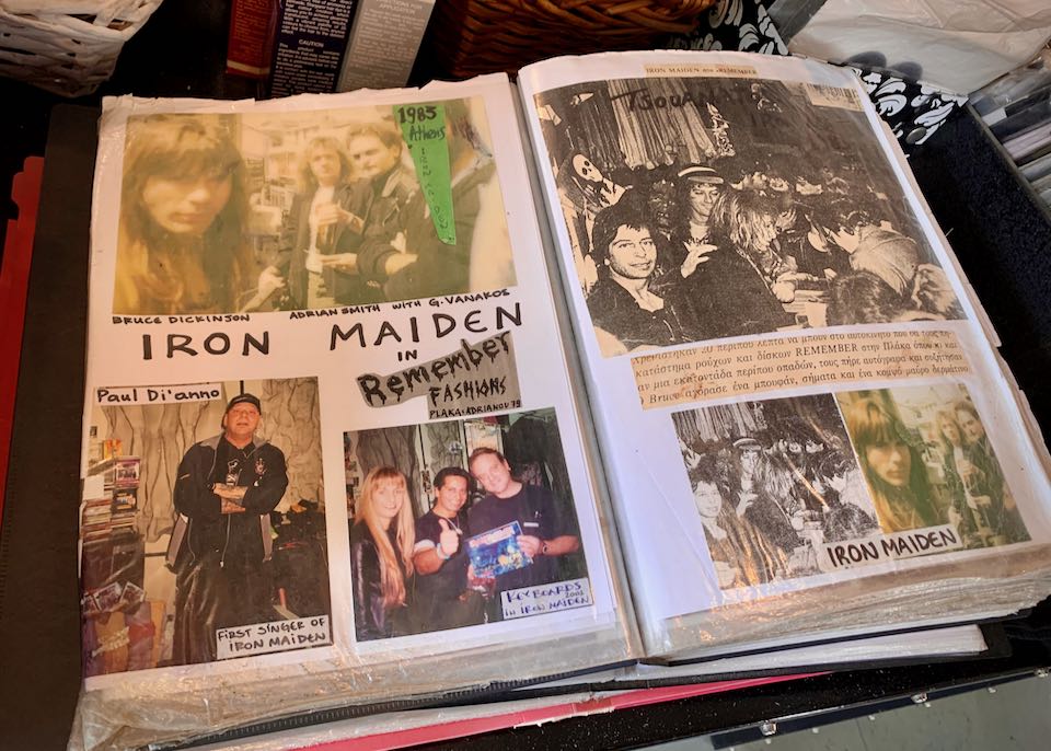 Photo album open to a page of photos of the band Iron Maiden