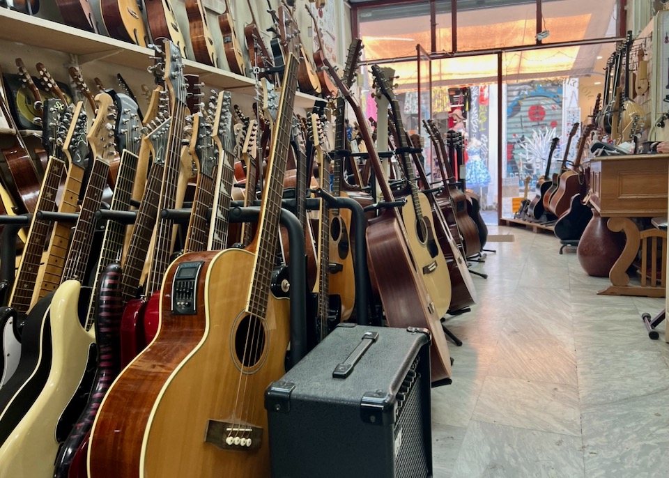 Rows of guitars and other stringed instruments in a music shop
