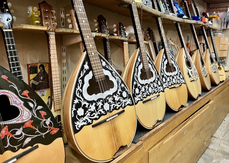 A row of beautifully-inlaid Greek stringed instruments