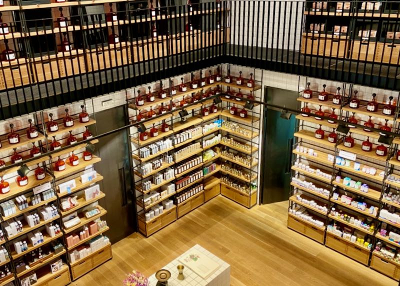 Overhead view of an apothecary with floor-to-ceiling shelves of beauty and wellness products