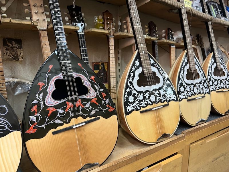 A line of beautiful hand-crafted Greek bouzoukis on a store shelf