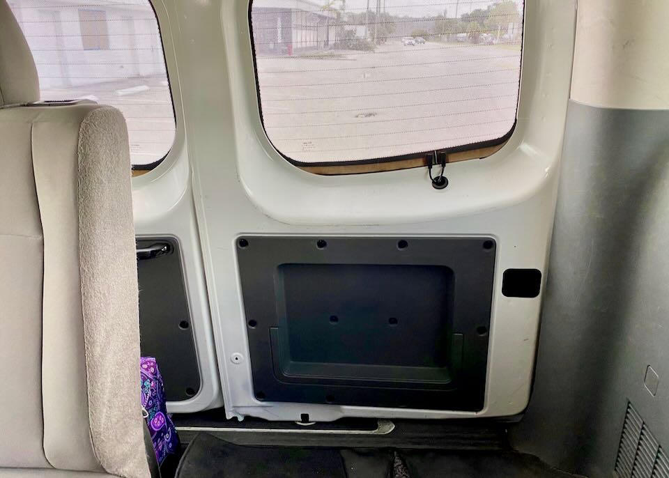 A small space in the back of the van holds luggage.
