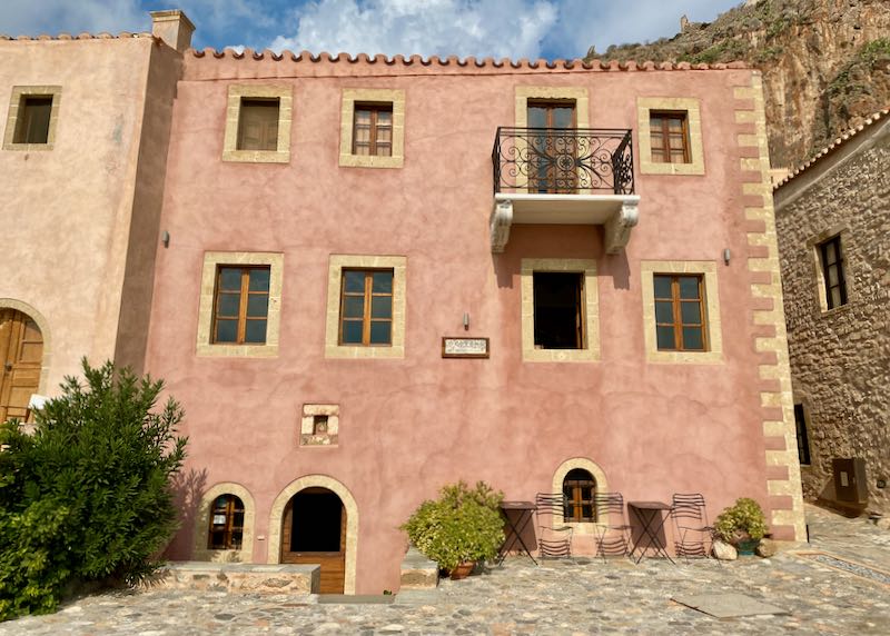 Pink stone building with rounded doorways in a castle settlement