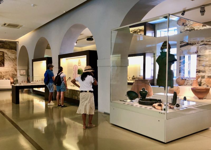 Tourists examine displays at the Archaeological Museum of Nafplio