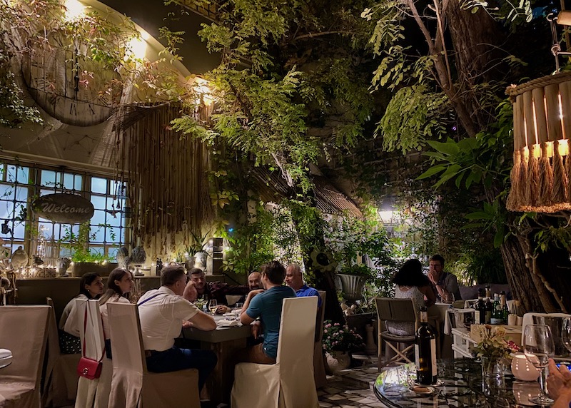 Dining in the garden of Aleria Restaurant in Metaxourgeio, Athens