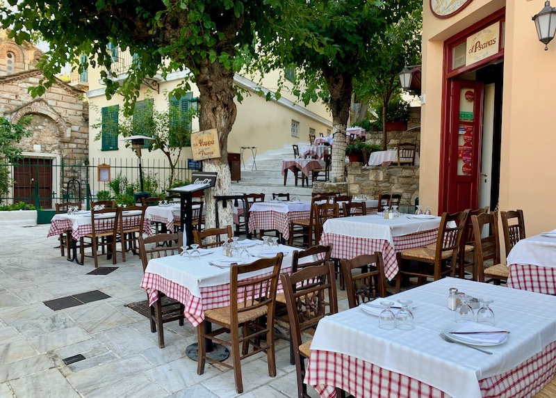 Tables on the patio and stairs at the Old Tavern of Psarras in Plaka, Athens