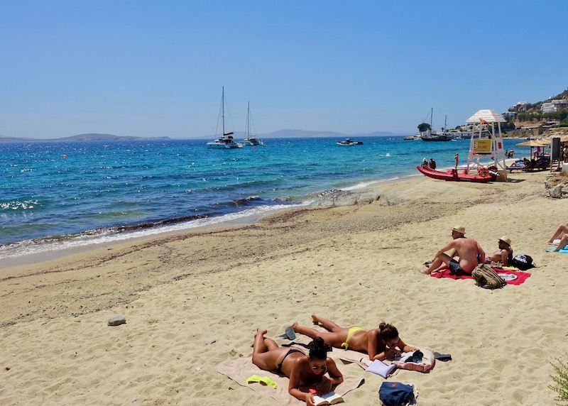 Sunbathers on the public side of Agios Ioannis Beach in Mykonos