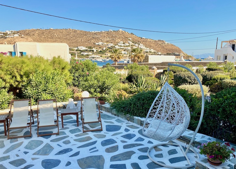 Garden terrace with a glimpse of the sea at Erato Hotel in Ornos, Mykonos