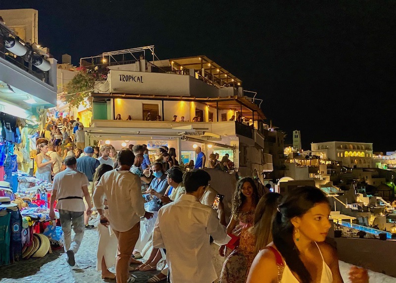 Busy pathway at night in front of Tropical Bar in Fira, Santorini.