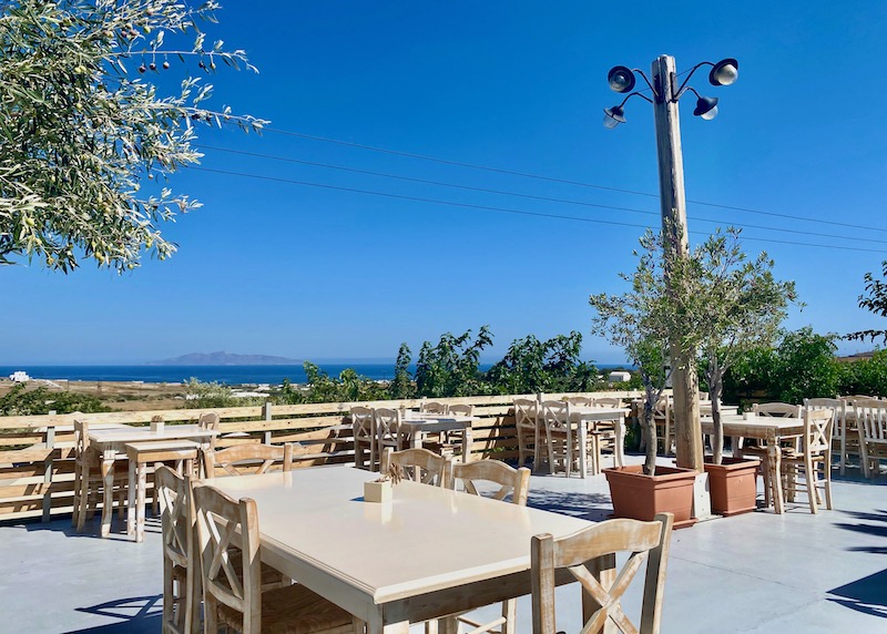 Al fresco dining terrace with a sea view at Aroma Avlis in Exo Gonia, Santorini
