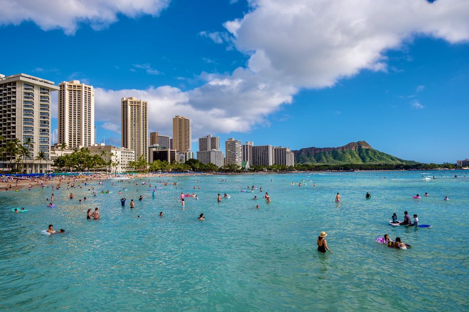 Beach in Honolulu with resorts and swimming.