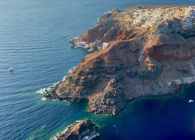 View of Oia and Ammoudi Bay from a helicopter in Santorini