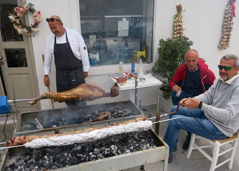 Lamb cooking on a spit over coals for Easter in Santorini