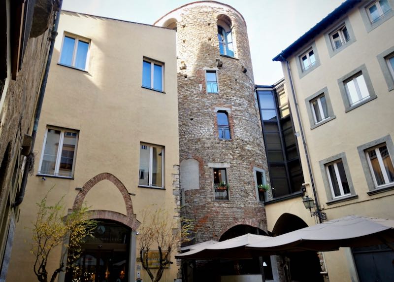 Exterior of a hotel with a large stone tower