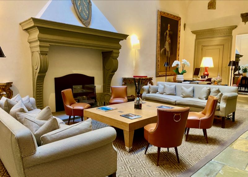 Sofas and chairs arranged in front of a stylish Florentine fireplace