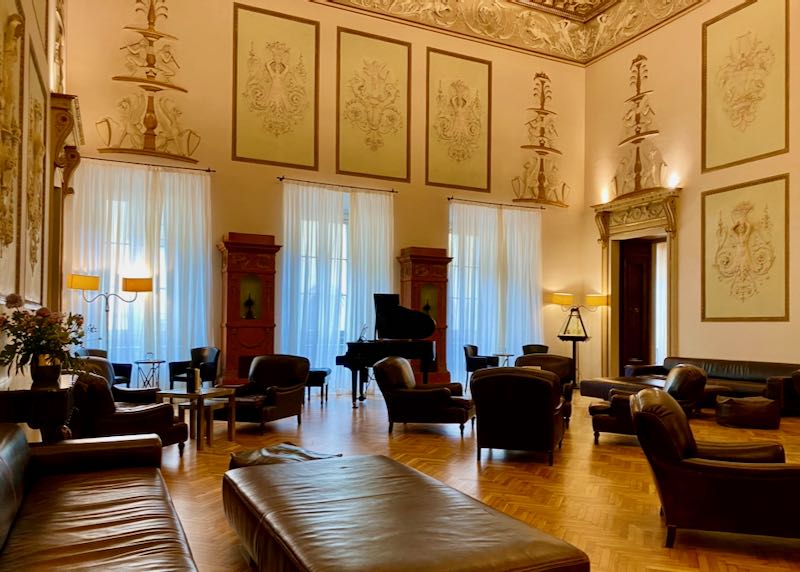Large palazzo room with high frescoed ceilings and leather couches