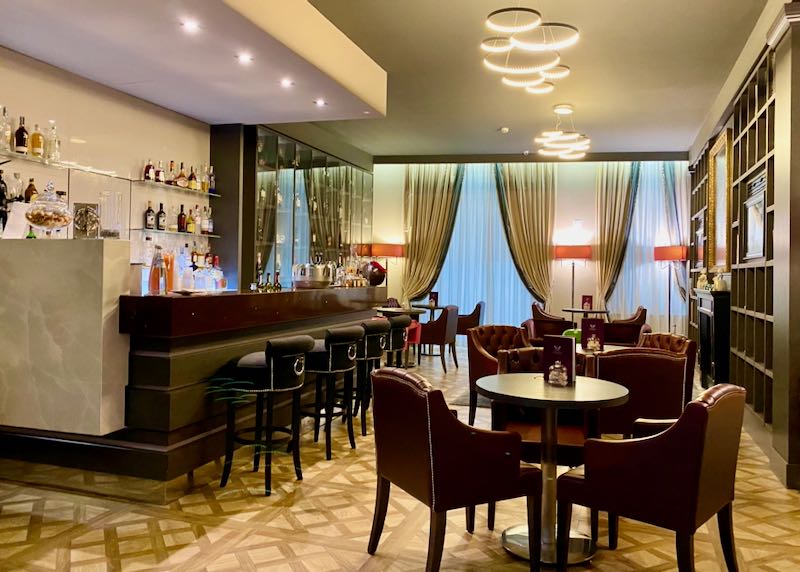 Hotel bar with parquet flooring and leather chairs
